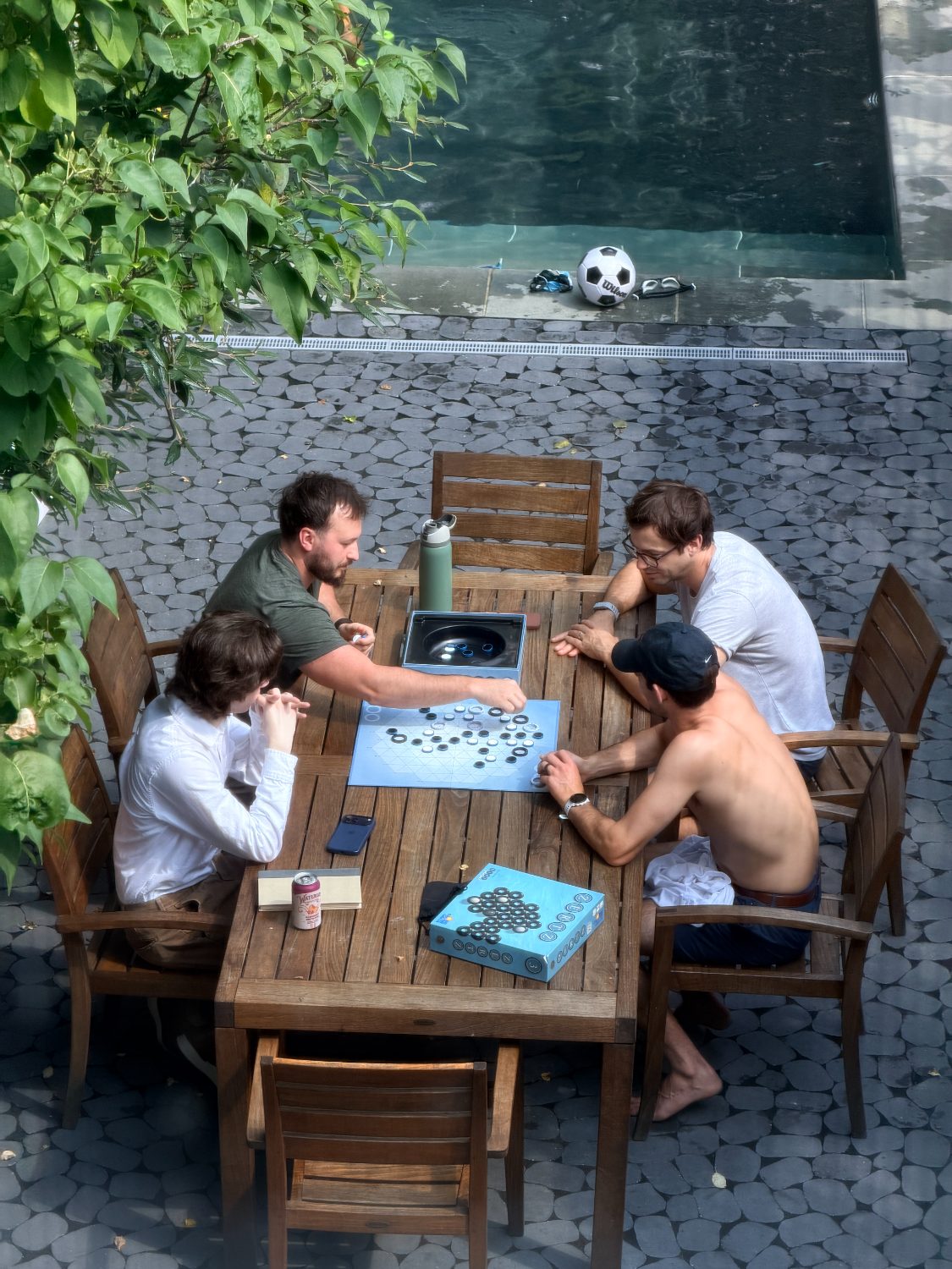 Playing games at the table beside the pool