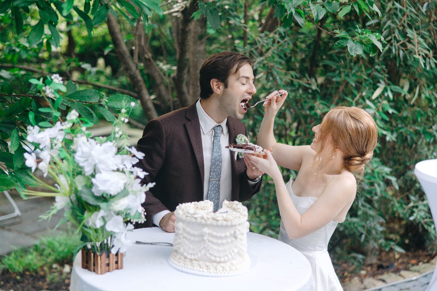 Cody and Katrina feeding each other cake