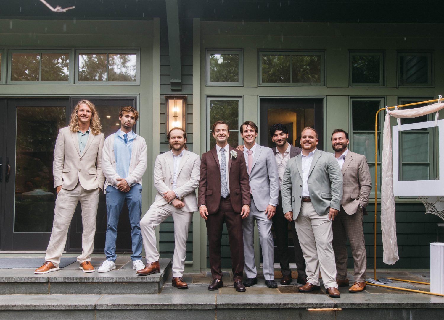 The groomsmen on the porch steps