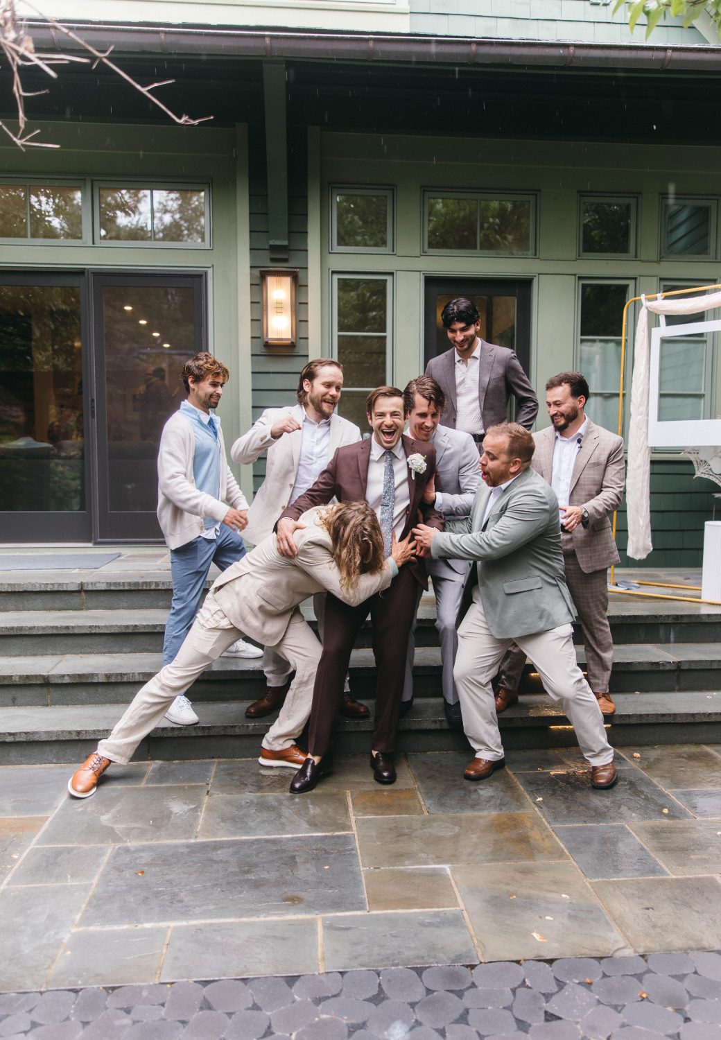 The groomsmen piled on the steps
