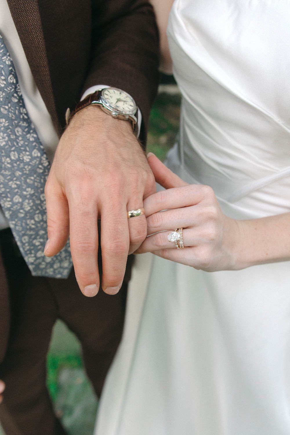 Their hands, with both rings
