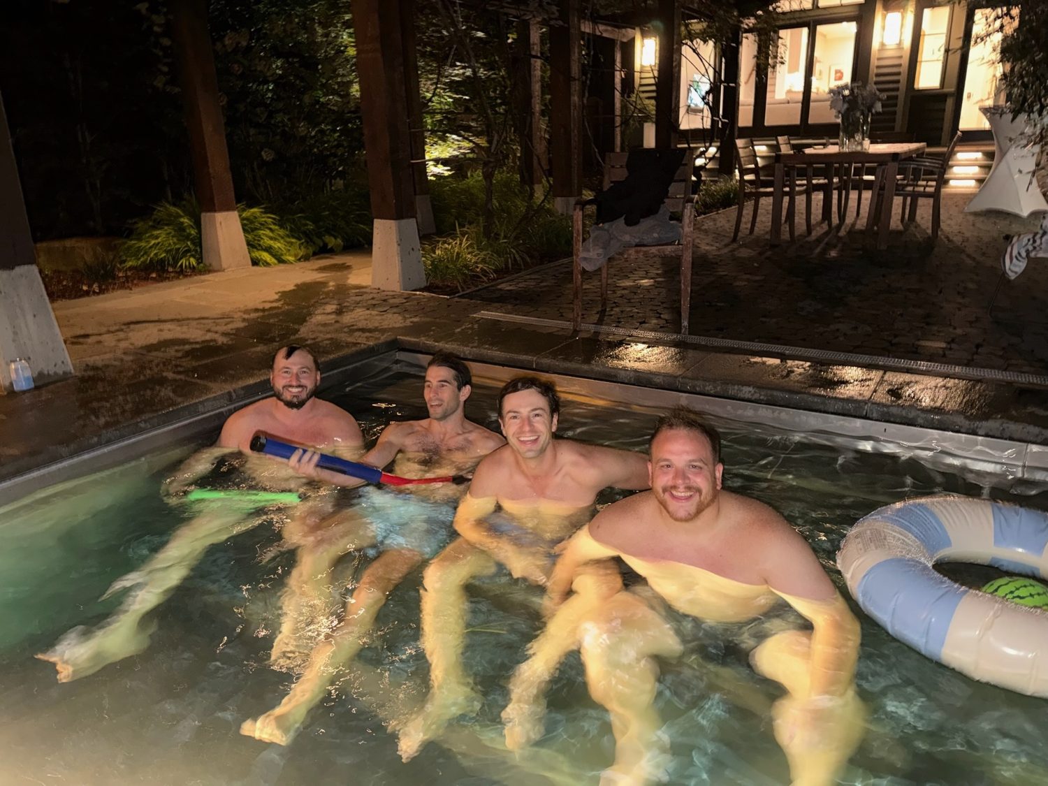 The guys floating in the pool late at night