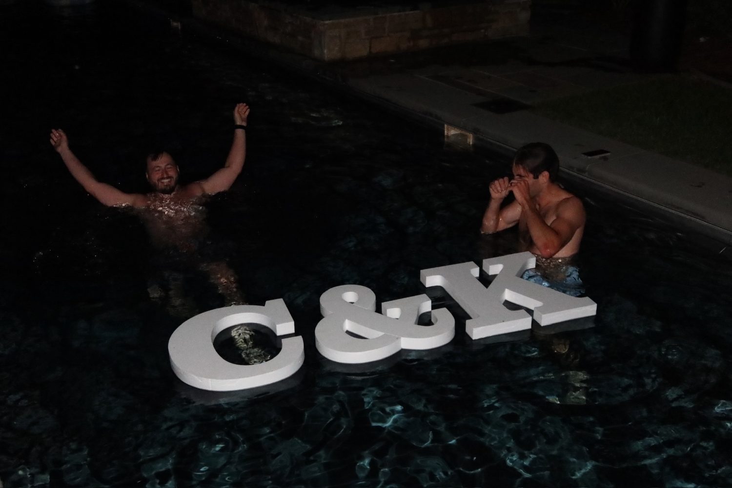 The C and K letters floating in the pool at night