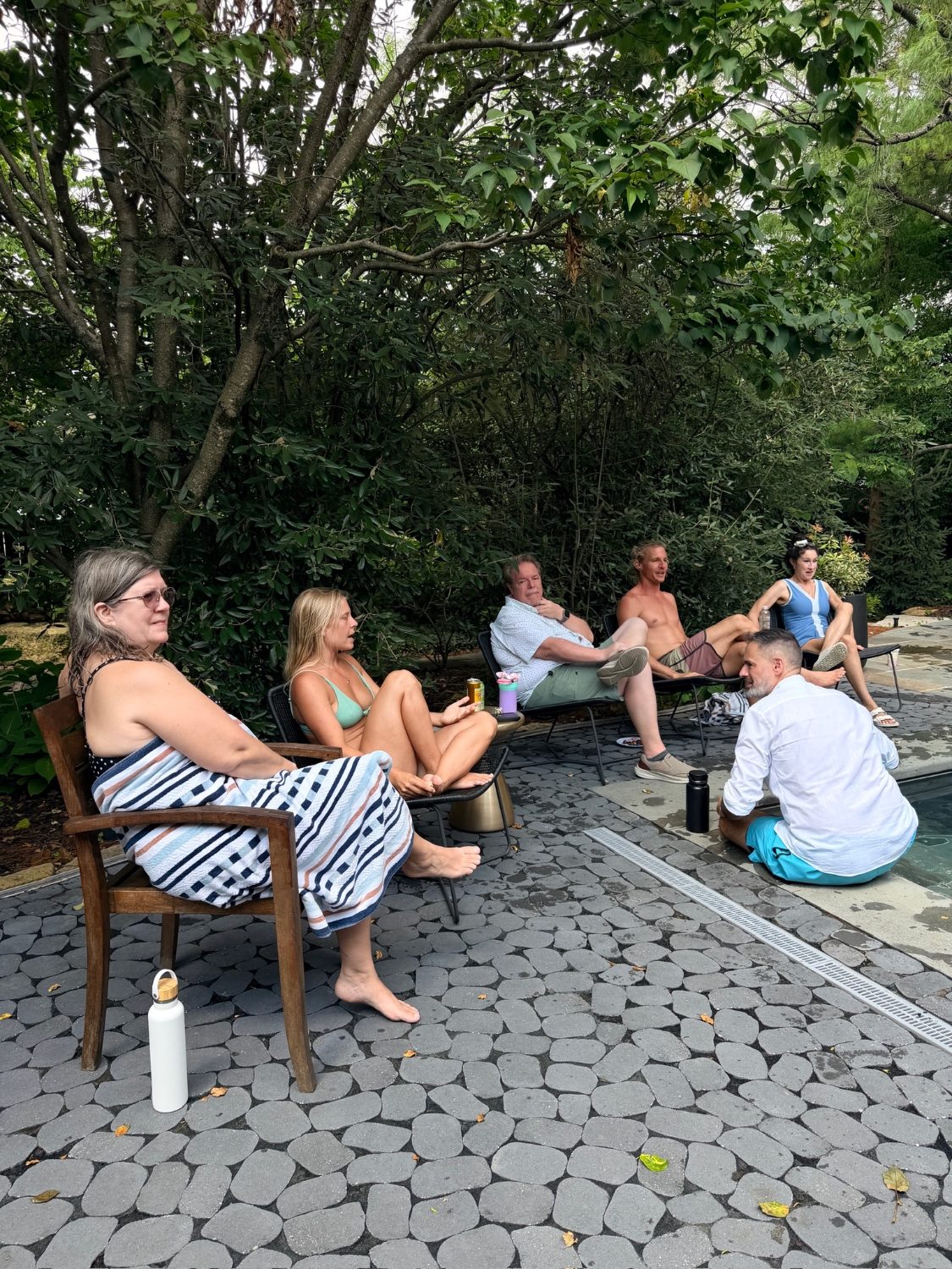 Everyone sitting around the pool deck in the afternoon