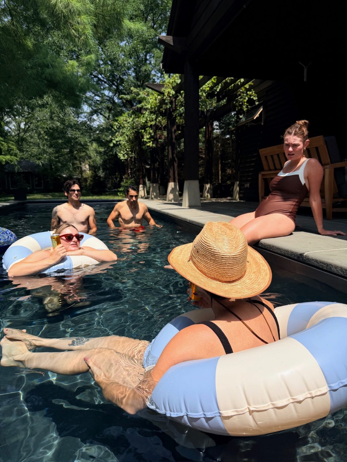 Floating in the pool in sun hats