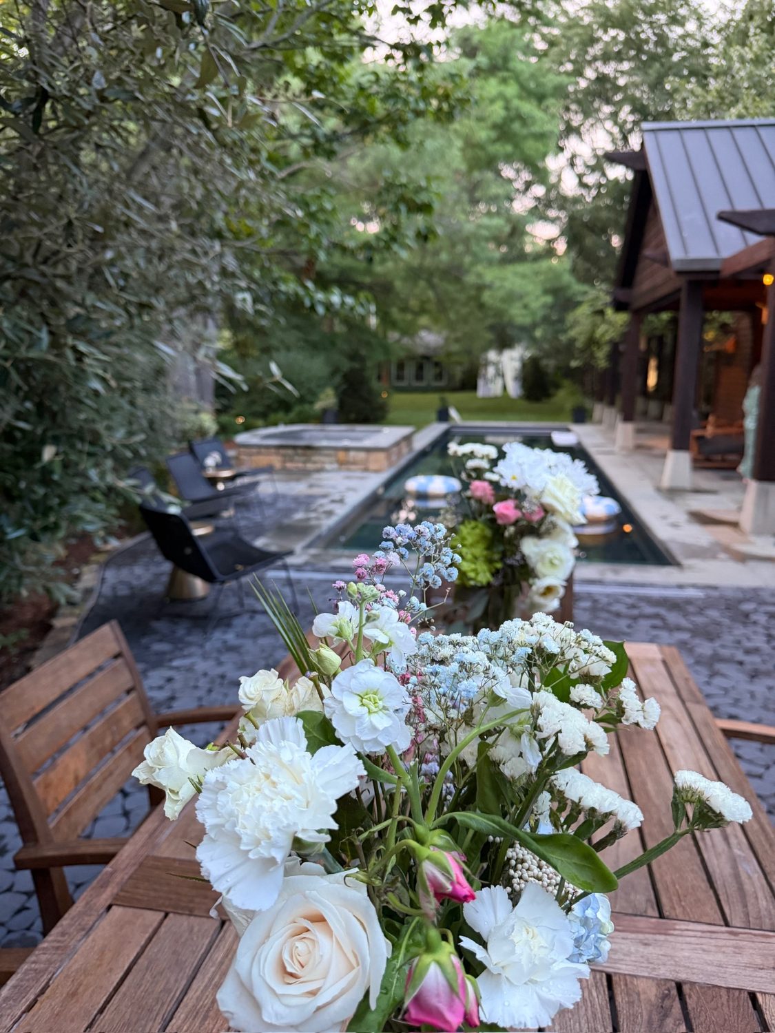 Bouquets from the day before, out on the table by the pool